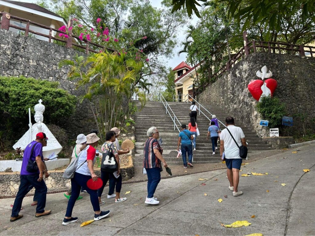 Devotees climb the steps leading to the Stations of the Cross in Tabor Hill in Barangay Talamban, Cebu City. 