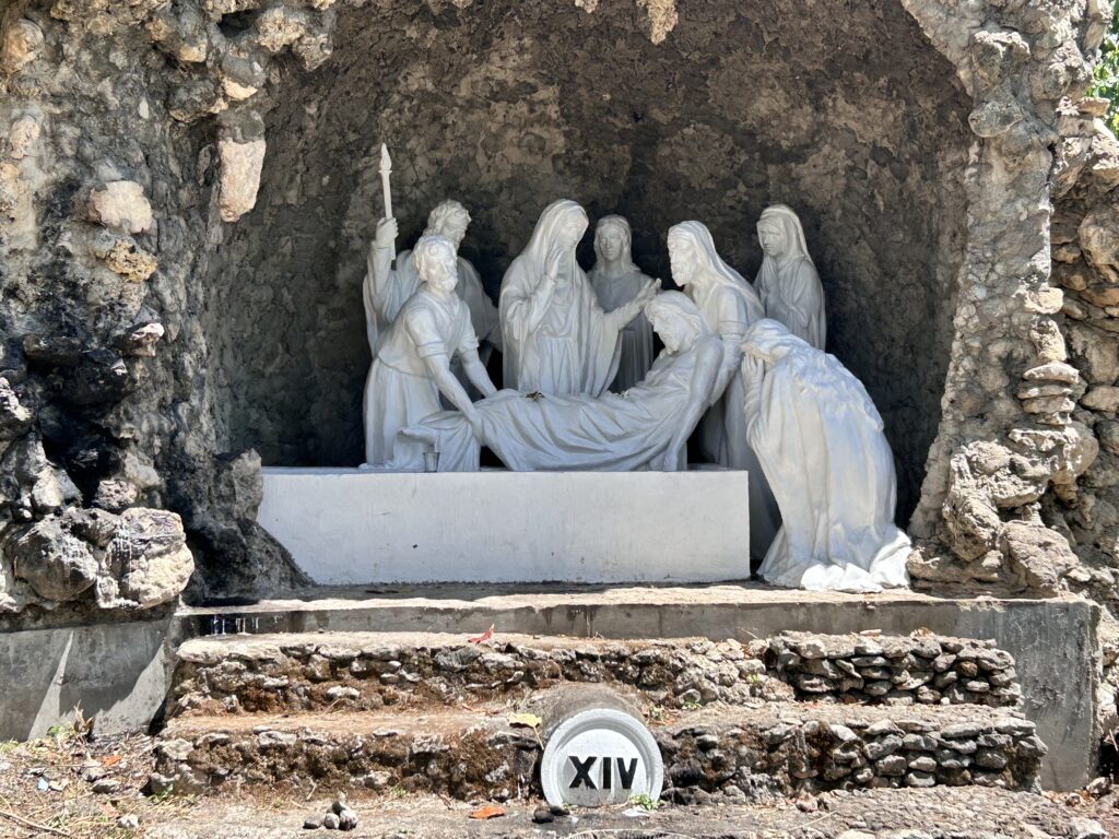 This is the scene in one of the stations of the cross in Good Shepherd where Jesus after having died from the cross in Calvary is buried in a cave.