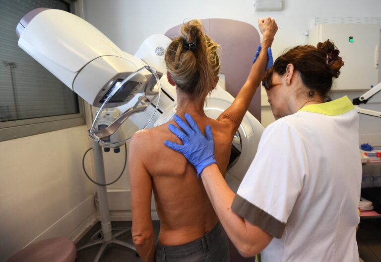 a patient is pictured before a mammography.