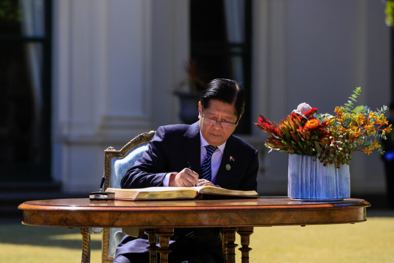 President Marcos pictured signing 