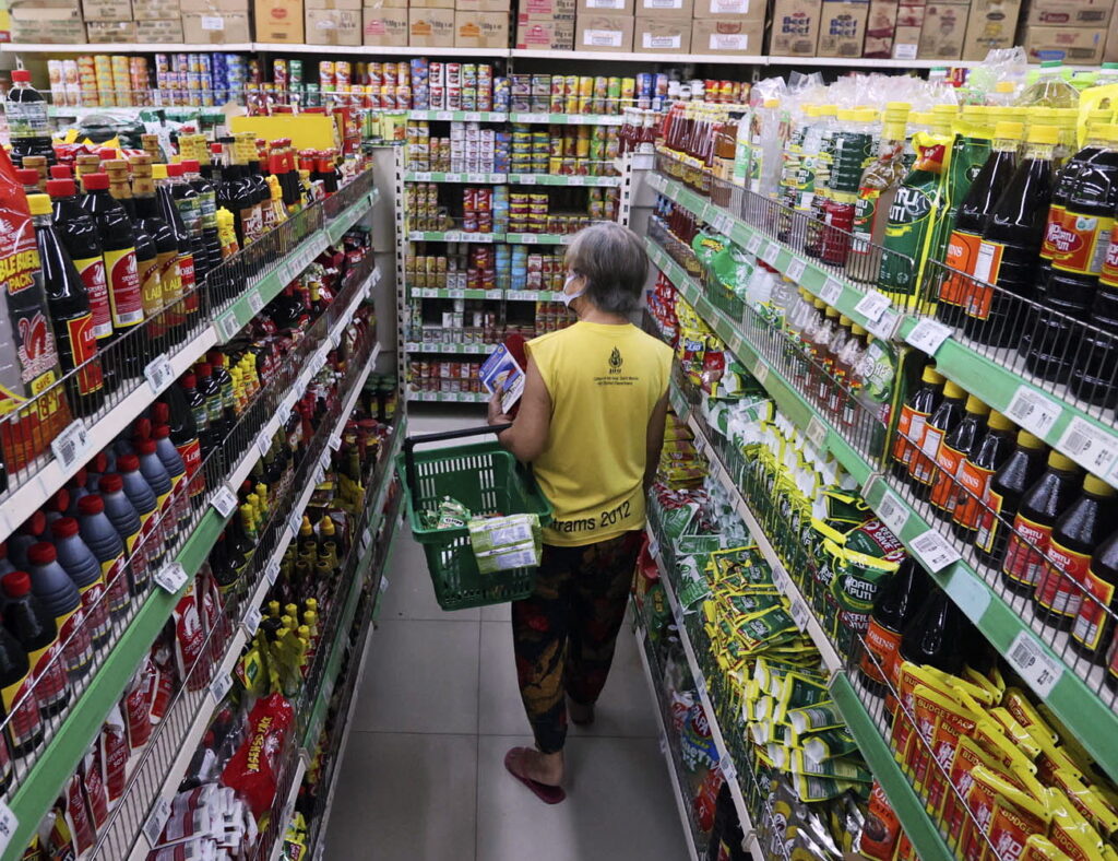 A senior citizen shopping at a grocery.