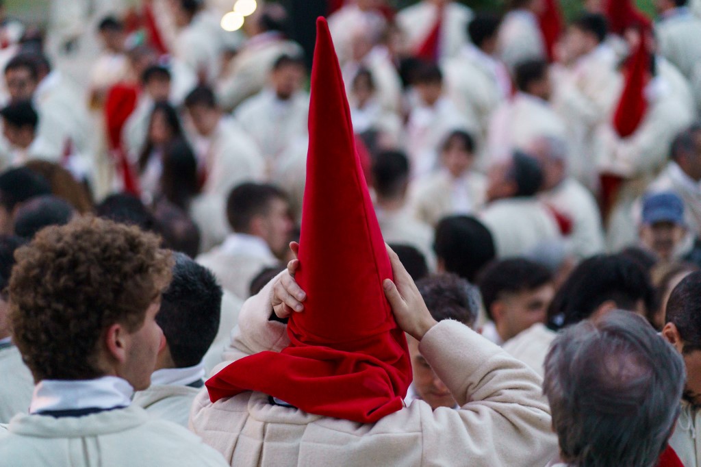 Penitents from the ‘Real Hermandad del Santisimo Cristo de las Injurias, Cofradia del Silencio’ brotherhood gather outside the cathedral prior to taking part in their procession, which was suspended due to the rain, during Holy Week in the northwestern Spanish city of Zamora.