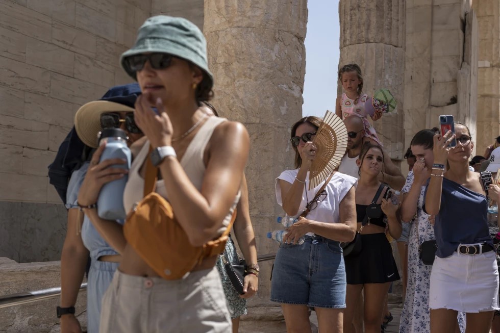 Tourists visit the ancient Acropolis hill during a heat wave in Athens, Greece, on July 21, 2023. 