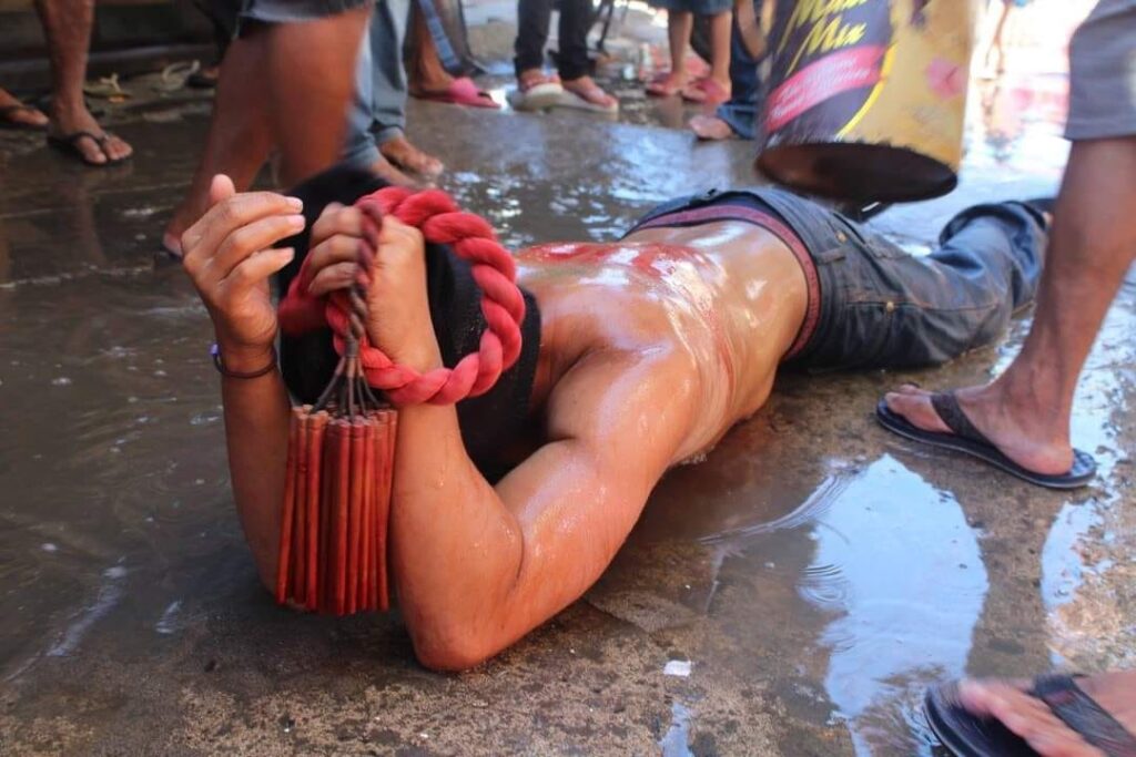 Whips for flogging as symbols of sufferings. A flagellant lie face down so that his back can be flogged.