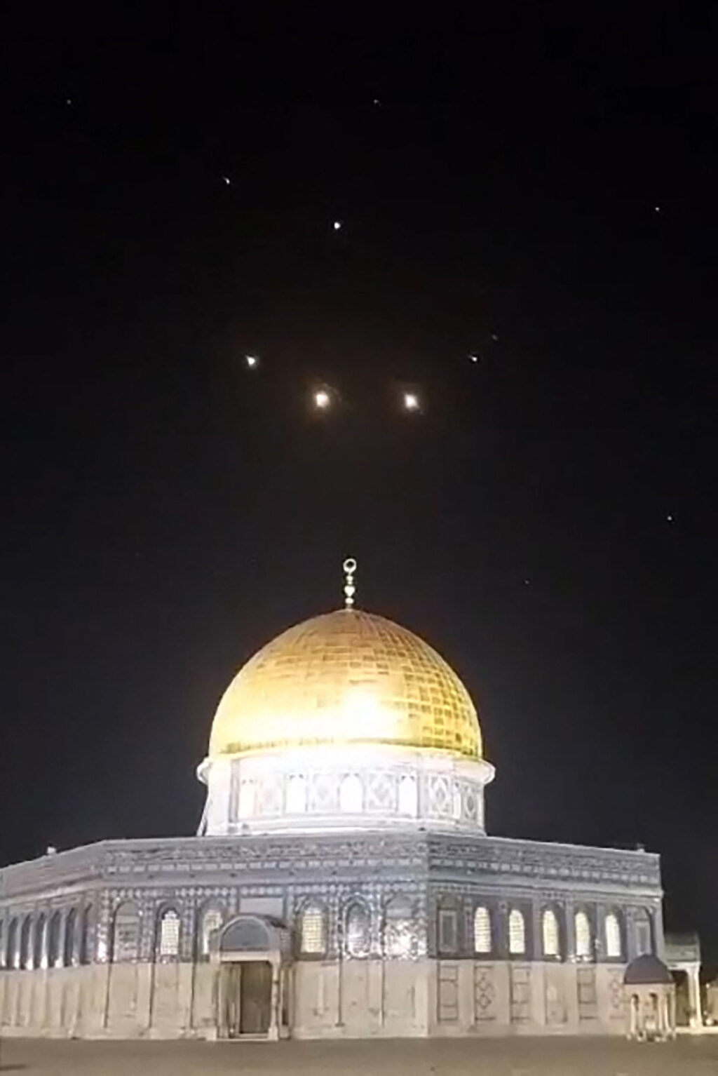 Iran attack on Israel: Why? Key events leading to military assault: An image-grab from a video taken early on April 14, 2024, shows rocket trails in the sky above the Al-Aqsa Mosque compound in Jerusalem. Iran launched its first-ever direct attack on Israeli territory late on April 13, marking a major escalation of the long-running covert war between the regional foes and sparking fears of a broader conflict breaking out. | AFP