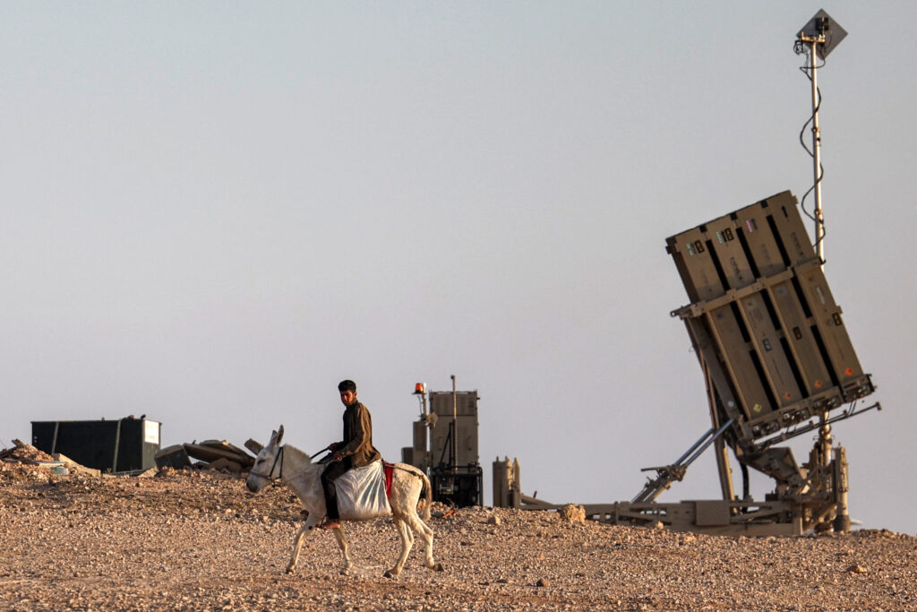 Iran attack on Israel: Why? Key events leading to military assault. A boy rides a donkey near one of the batteries of Israel's Iron Dome missile defence system at a village not recognised by Israeli authorities in the southern Negev desert on April 14, 2024.| AFP