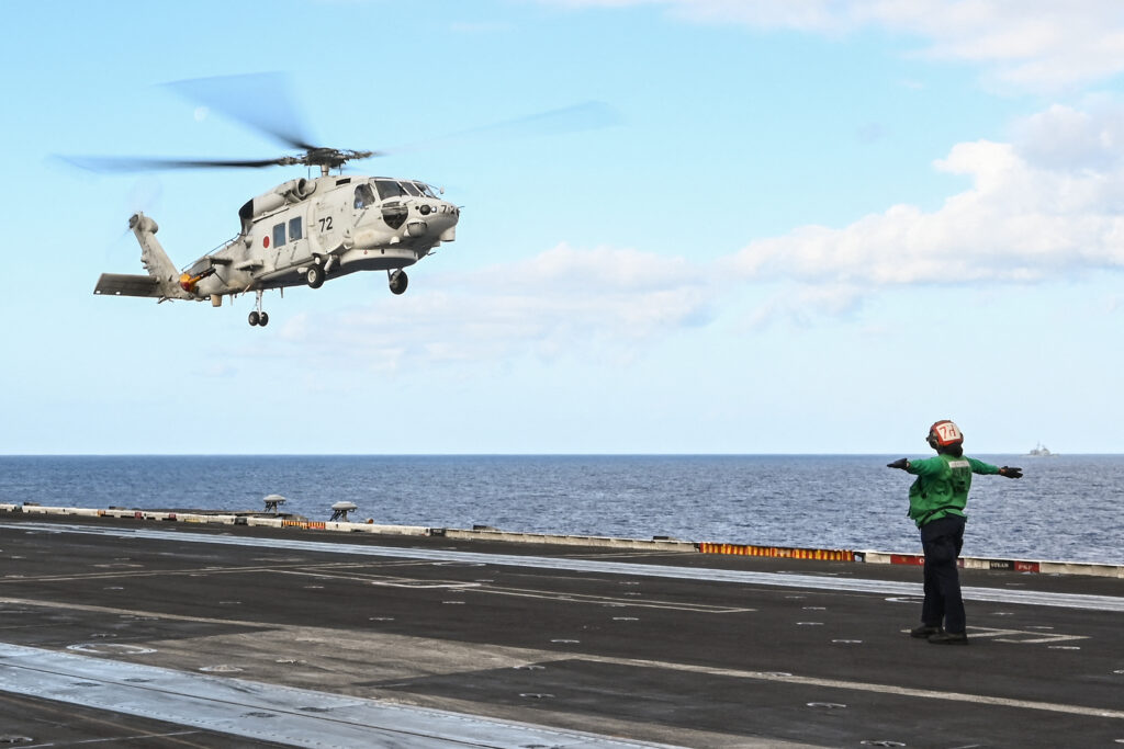 Japan Navy helicopters crash: Major search operation ongoing. Photo is ntaken on January 31, 2024 shows a Japan Maritime Self-Defense Force SH-60K helicopter landing on the deck of the USS Carl Vinson aircraft carrier during a three-day maritime exercise between the US and Japan in the Philippine Sea. | AFP