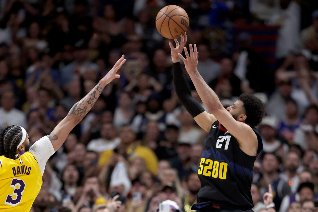 Jamal Murray #27 of the Denver Nuggets puts up a last second shot against Anthony Davis #3 in the fourth quarter to defeat the Los Angeles Lakers during game two of the Western Conference First Round Playoffs at Ball Arena on April 22, 2024 in Denver, Colorado. Getty Images via AFP
