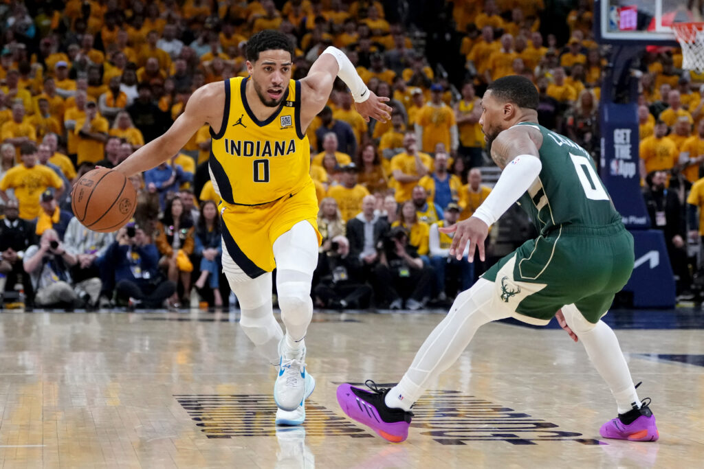 NBA: Pacers hold off Bucks in OT, take 2-1 . lead. Tyrese Haliburton #0 of the Indiana Pacers dribbles the ball while being guarded by Damian Lillard #0 of the Milwaukee Bucks in overtime during game three of the Eastern Conference First Round Playoffs at Gainbridge Fieldhouse on April 26, 2024 in Indianapolis, Indiana. | Getty Images via AFP
