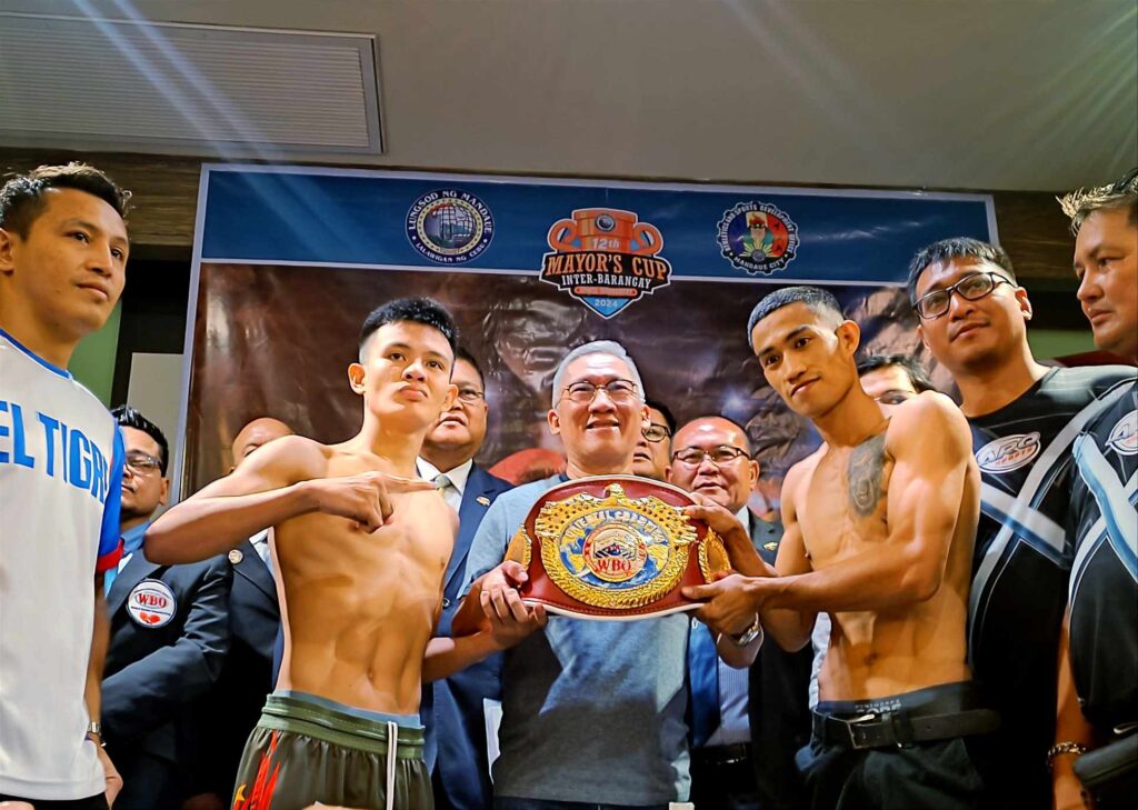 Mandaue boxing: All set for Labor Day WBO regional title bouts. Ramil Macado (right) and Lorenz Dumam-ag hold the WBO Oriental flyweight title with Mandaue City Mayor Jonas Cortes during the weigh-in. | Glendale Rosal