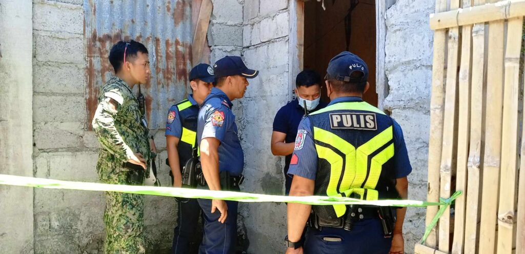 Girl killed in Talisay: Was it a case of accidental shooting? In photo are policemen investigating the shooting where a 14-year-old girl answeing her modules inside her house was killed on April 26. | Paul Lauro