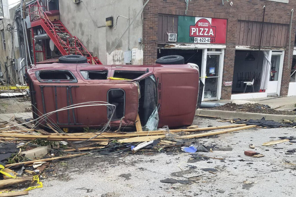 Tornadoes kill 4 in Oklahoma. A car lies knocked over on its side after a tornado tore through Sulphur, Okla., Sunday, April 28, 2024. (AP Photo/Ken Miller)
