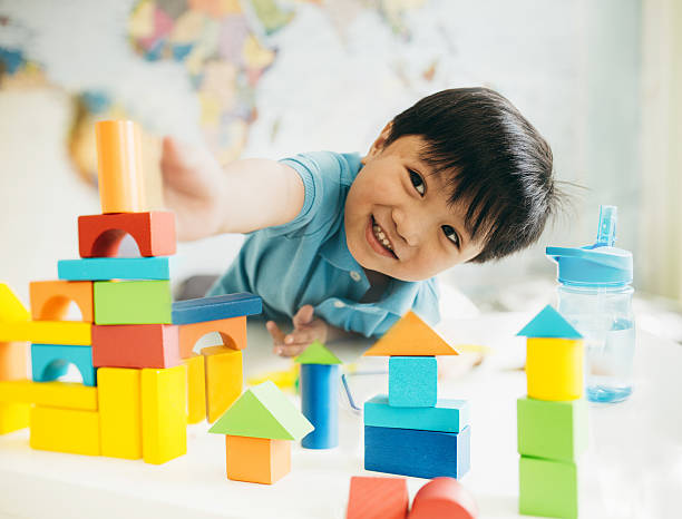 Energy saving for family with newborns - A young boy plays with his blocks