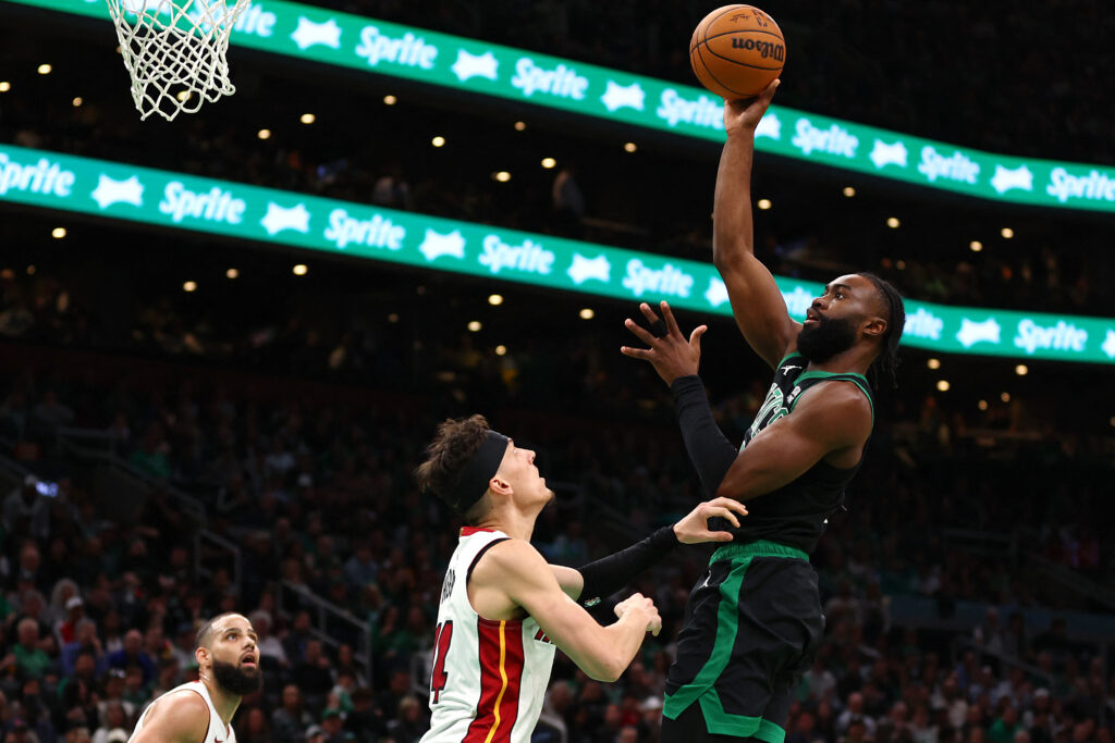 Jaylen Brown #7 of the Boston Celtics takes a shot over Tyler Herro #14 of the Miami Heat during the third quarter of game five of the Eastern Conference First Round Playoffs at TD Garden on May 01, 2024 in Boston, Massachusetts.| Getty Images via AFP