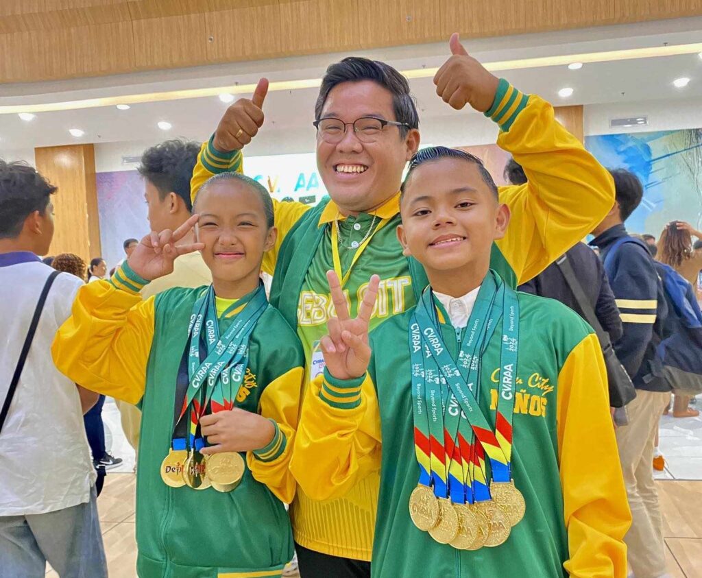 CVIRAA 2024: Cebu City Niños dominates dancesport event . Sheen Nhewby Talara and Dave Rayvin Rosaldo with their coach Richard Ilustrisimo. | Contributed photo