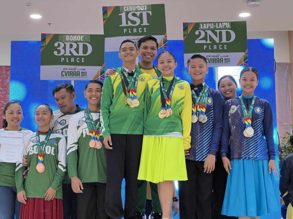 CVIRAA 2024: Cebu City Niños dominates dancesport event. Rhys Rhafael Fajardo and Shadelle Niña Hernandez with their coach Aldrin Ubas. | Contributed photo