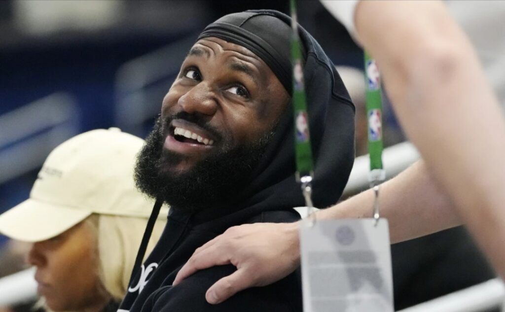 Los Angeles Lakers star LeBron James smiles ashe talks with a media member while he watches his son Bronny James during the 2024 NBA Draft Combine 5-on-5 basketball game between Team St. Andrews and Team Love in Chicago Wednesday, May 15, 2024.
