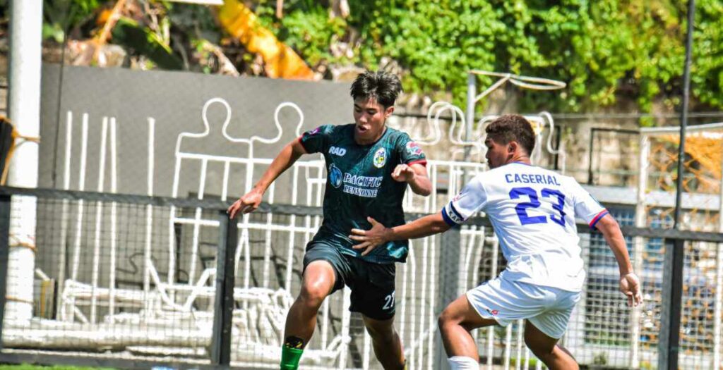 A player from CVFA (green uniform) and a Davao South RFA player during the 2023 PFF U19 Boys National Championship 2023 First Division in Cebu.