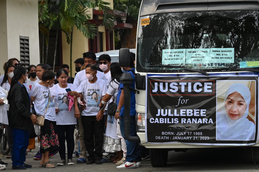 Relatives of Jullebee Ranara, a domestic helper who was killed in Kuwait, grieve during her funeral at a cemetery in Las Pinas, Metro Manila on February 5, 2023. | AFP FILE PHOTO