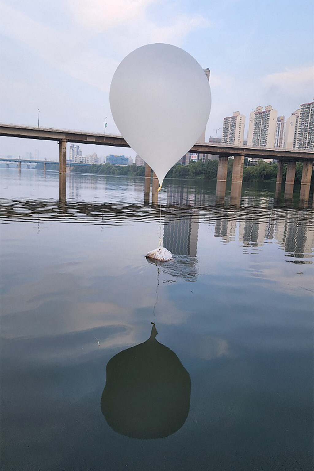 K-pop vs trash: 2 Koreas start bizarre psychological warfare, tensions up. PHOTO is a handout photo taken on June 9, 2024 and provided by the South Korean Defence Ministry shows an unidentified object believed to be a North Korean trash-filled balloon, on the surface of the Han River near Jamsil Bridge in Seoul. North Korea has sent hundreds more trash-filled balloons across the border in a fresh blitz, Seoul's military said on June 9, as the tit-for-tat balloon barrages between the two neighbours accelerates. | AFP