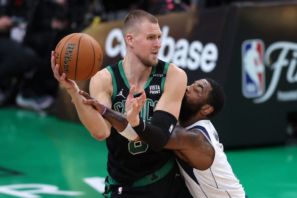 Kristaps Porzingis #8 of the Boston Celtics is defended by Kyrie Irving #11 of the Dallas Mavericks during the fourth quarter in Game Two of the 2024 NBA Finals at TD Garden on June 09, 2024 in Boston, Massachusetts. | Getty Images via AFP