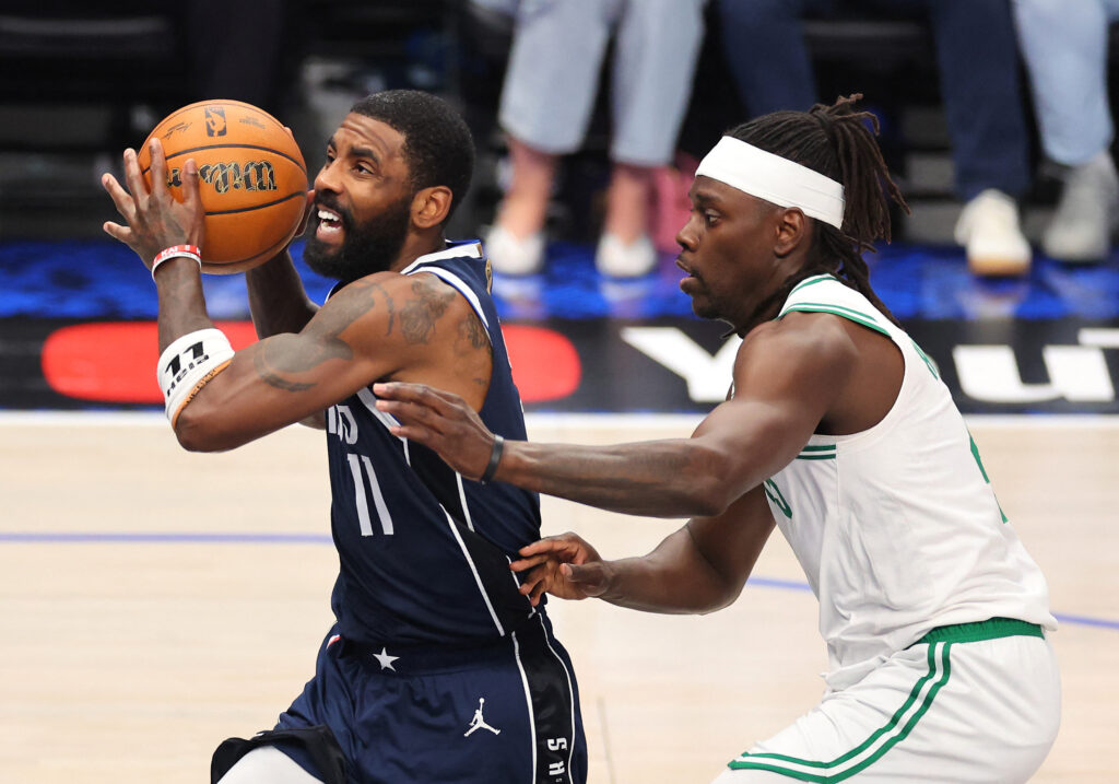 NBA Finals: Irving aims to focus as Mavericks fights to survive in Boston in Game 5. In photo is Kyrie Irving #11 of the Dallas Mavericks driving to the basket against Jrue Holiday #4 of the Boston Celtics during the second quarter in Game Four of the 2024 NBA Finals at American Airlines Center on June 14, 2024 in Dallas, Texas. | Getty Images via AFP