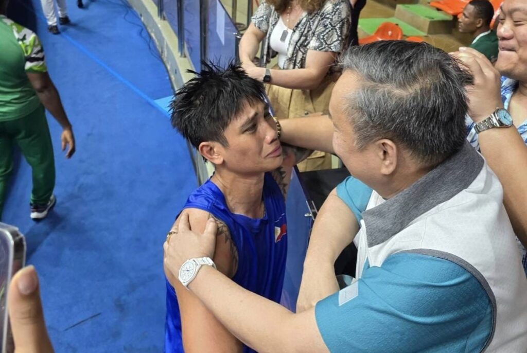 Bacyadan beats Venezuelan foe, qualifies for Paris Olympics. Hergie Bacyadan is seen being emotional while approaching POC chief Abraham 'Bambol' Tolentino after qualifying in the Paris Olympics. | Photo from Tolentino's Facebook page