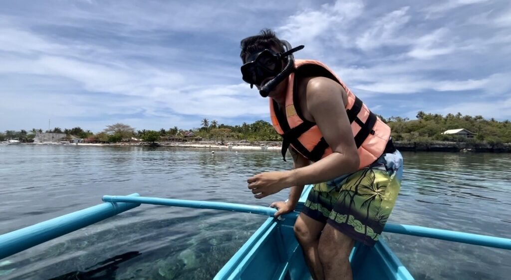 A local tourist prepares to go snorkeling in the island's waters.