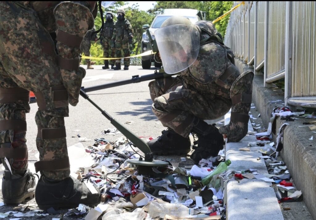 South Korean soldiers wearing protective gearscheck the trash from a balloon presumably sent
by North Korea, in Incheon, South Korea, Sunday
June 2, 2024