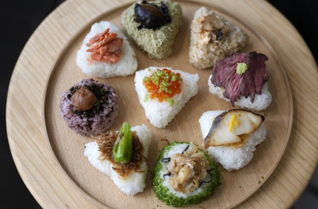 A variety of onigiri, rice balls, are seen on a plate at a Taro Tokyo Onigiri shop in Tokyo, on June 5, 2024. The word "onigiri" just became part of the Oxford English Dictionary this year. The humble sticky-rice ball, a mainstay of Japanese food, has entered the global lexicon.