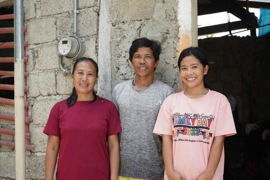 The smiles painted on the faces of Analou and her family resemble the meaningful change electricity brought to their family.