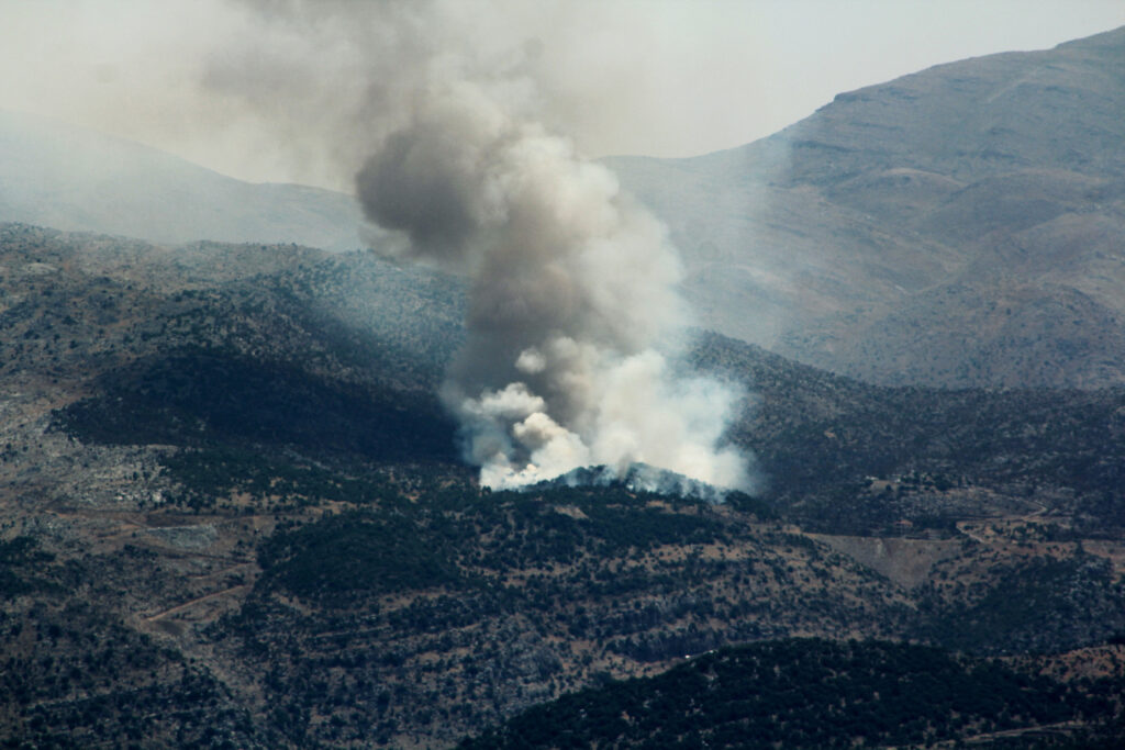 Smoke billows from forest fires near the southern Lebanese village of Shebaa, close to the northern border of Israel, following the shooting down of a drone by  the Israeli army on July 4, 2024, amid the ongoing cross-border clashes between Israeli troops and Hezbollah fighters. | AFP