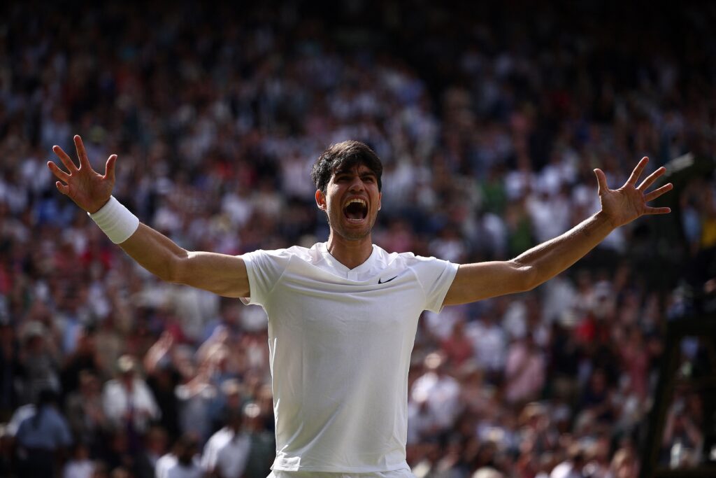 Spain's Carlos Alcaraz celebrates beating Serbia's Novak Djokovic during their men's singles final tennis match on the fourteenth day of the 2024 Wimbledon Championships at The All England Lawn Tennis and Croquet Club in Wimbledon, southwest London, on July 14, 2024. Defending champion Alcaraz beat seven-time winner Novak Djokovic in a blockbuster final, with Alcaraz winning 6-2, 6-2,7-6. | AFP