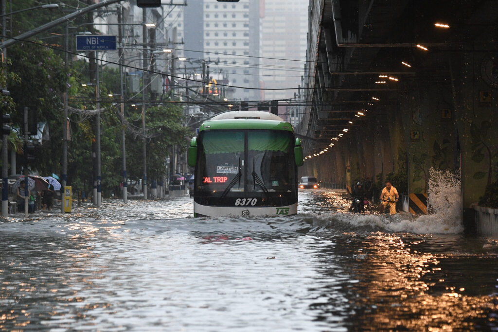 Taiwan prepares for typhoon that left 12 dead in Philippines. A passenger bus traverses along a flooded street in Manila on July 24, 2024 amid heavy rains brought by Typhoon Gaemi. (Photo by Ted ALJIBE / AFP)