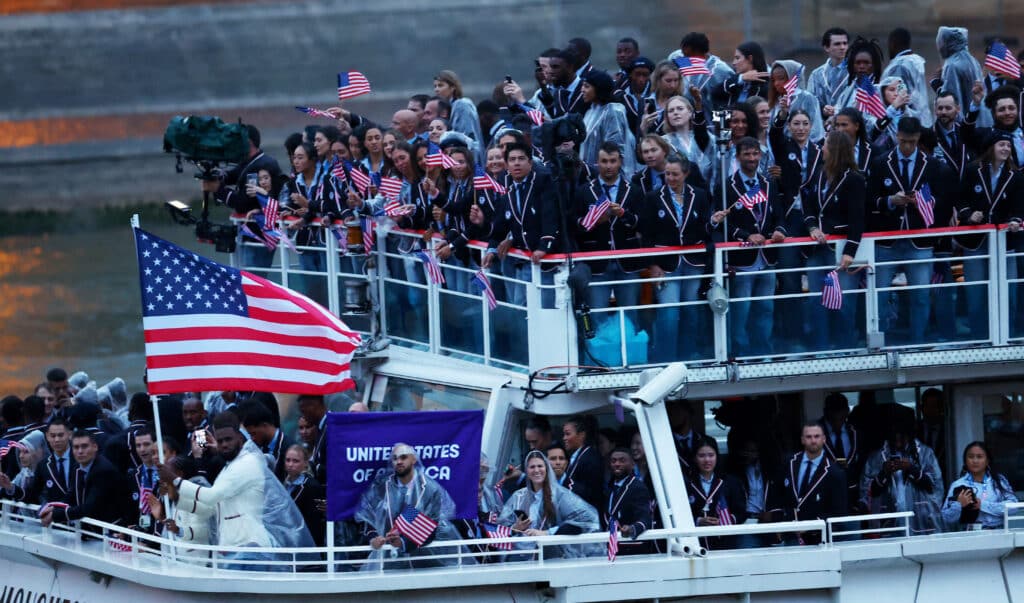 Paris 2024 Olympics - Opening Ceremony - Paris, France - July 26, 2024. Flagbearer LeBron James of US leads his contingent in the floating parade on the river Seine during the opening ceremony. (Photo by Esa Alexander / POOL / AFP)