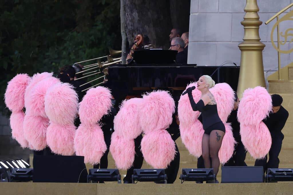 US' singer Lady Gaga sings at the Sully bridge area prior to the opening ceremony of the Paris 2024 Olympic Games in Paris on July 26, 2024. (Photo by Emmanuel DUNAND / AFP)