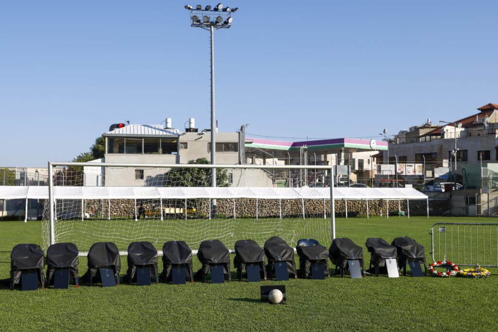 Israel vows retaliation after rocket kills 12 youths in Golan. Chairs covered in black representing 12 members of the Druze community killed in a rocket strike from Lebanon, are lined up in the football pitch where the attack took place, during their funeral in the Druze town of Majdal Shams in the Israel-annexed Golan Heights, on July 28, 2024. | AFP