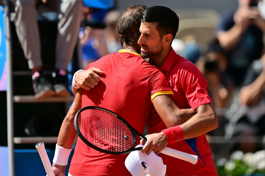  Winner, Serbia's Novak Djokovic (R) embraces Spain's Rafael Nadal (L) after their men's singles second round tennis match on Court Philippe-Chatrier at the Roland-Garros Stadium in Paris. | AFP