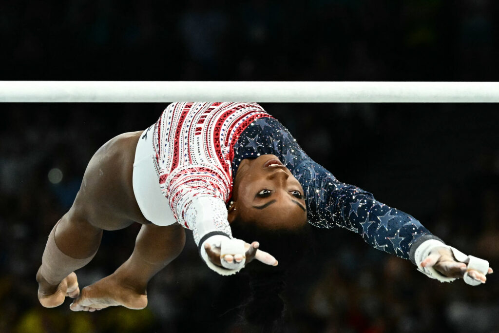 US' Simone Biles competes in the uneven bars event of the artistic gymnastics women's team final.