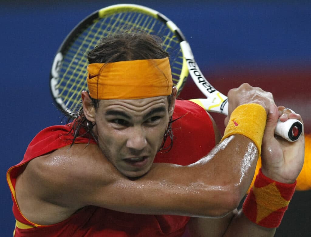 Olympics tennis blockbuster: Nadal says Djokovic 'clear favorite' . [FILE PHOTO] Rafael Nadal of Spain plays against Novak Djokovic from Serbia during a men's singles semi-final tennis match at the Olympic Green Tennis Centre in Beijing on August 15, 2008, during the 2008 Beijing Olympics. AFP PHOTO/BEHROUZ MEHRI (Photo by BEHROUZ MEHRI / AFP)