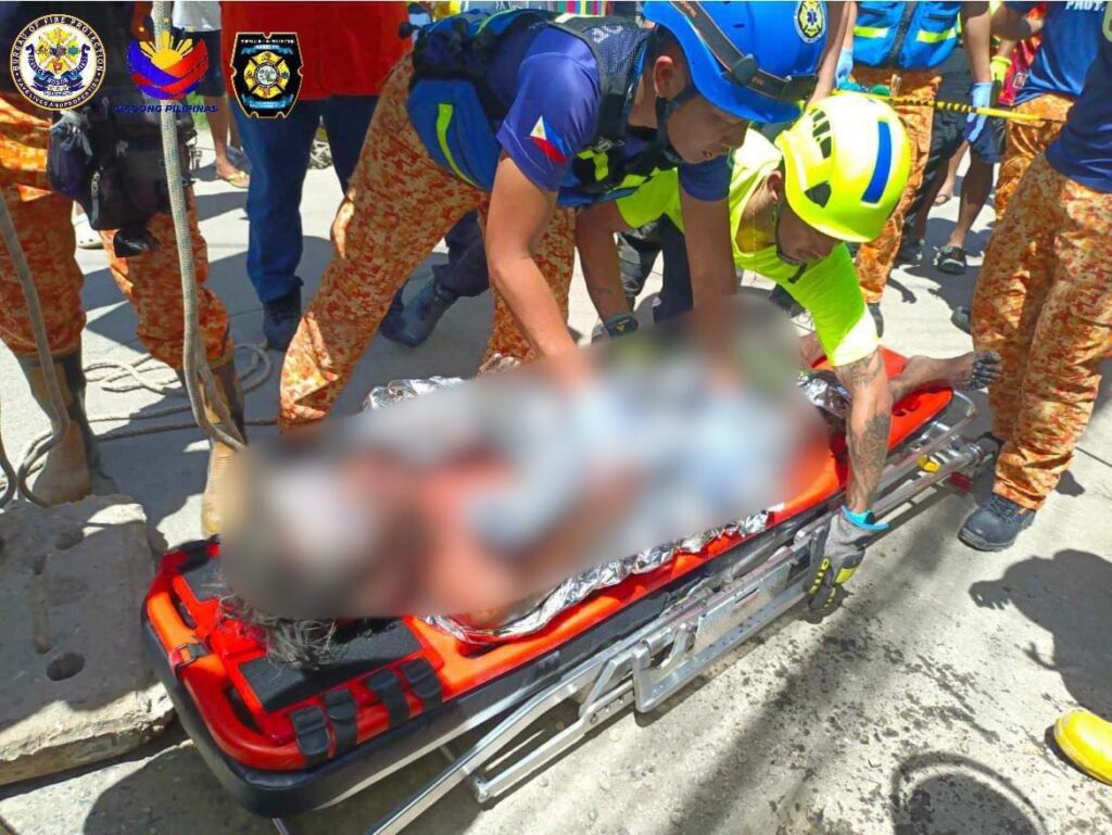 Emergency responders prepare the "Blue Man," who was trapped and rescued from a drainage in Sitio Sudlon, Barangay Maguikay, Mandaue City on June 30, is being readied to be brought to the hospital. | Contributed photo