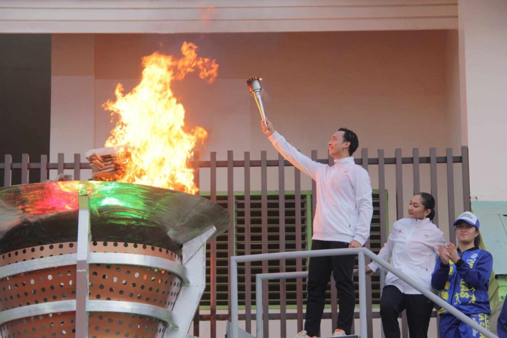 The lighting of the urn ceremony during the opening of the Palarong Pambansa 2024 was performed by Cebu's 2019 Southeast Asian Games (SEAG) gold medalists in dancesport, Wilbert Aunzo and Perl Marie Cañeda. | Photo: Josh Almonte