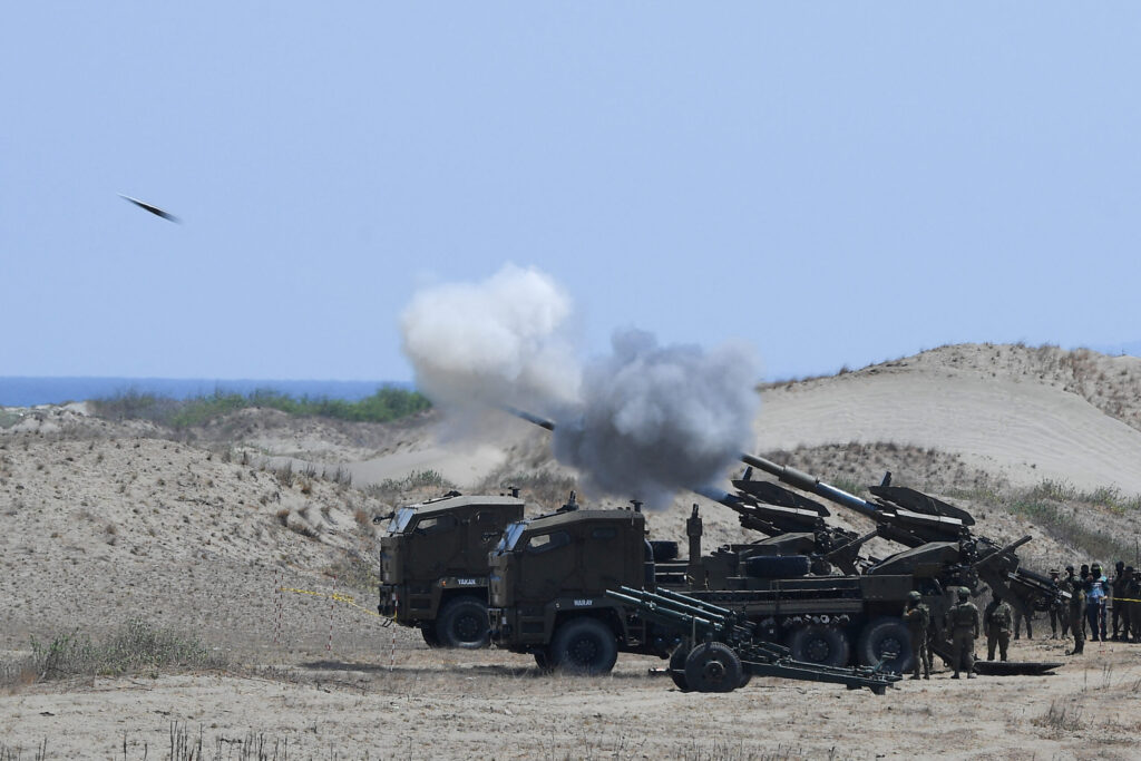NSC: No ‘imminent attack from China despite Sen. Marcos’ warning. Philippine army personnel fire their Autonomous Truck Mounted howitzer system (ATMOS), a 155 mm calibre self-propelled gun system, during the maritime strike exercise as part of the joint US-Philippines annual military Balikatan drills on a strip of sand dunes in Laoag on Luzon island’s northwest coast on May 8, 2024. FILE PHOTO/Agence France-Presse