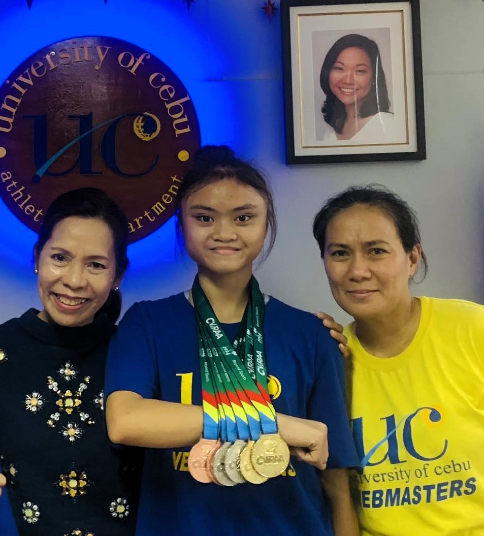 Cebuana gymnast aims to emulate SEA Games gold medalist. In photo is Georgina Shanelle Villaruel (middle) is flanked by UC Webmasters athletic director Jessica Honoridez (left) and her coach Darlene Dela Pisa (right). | Contributed photo