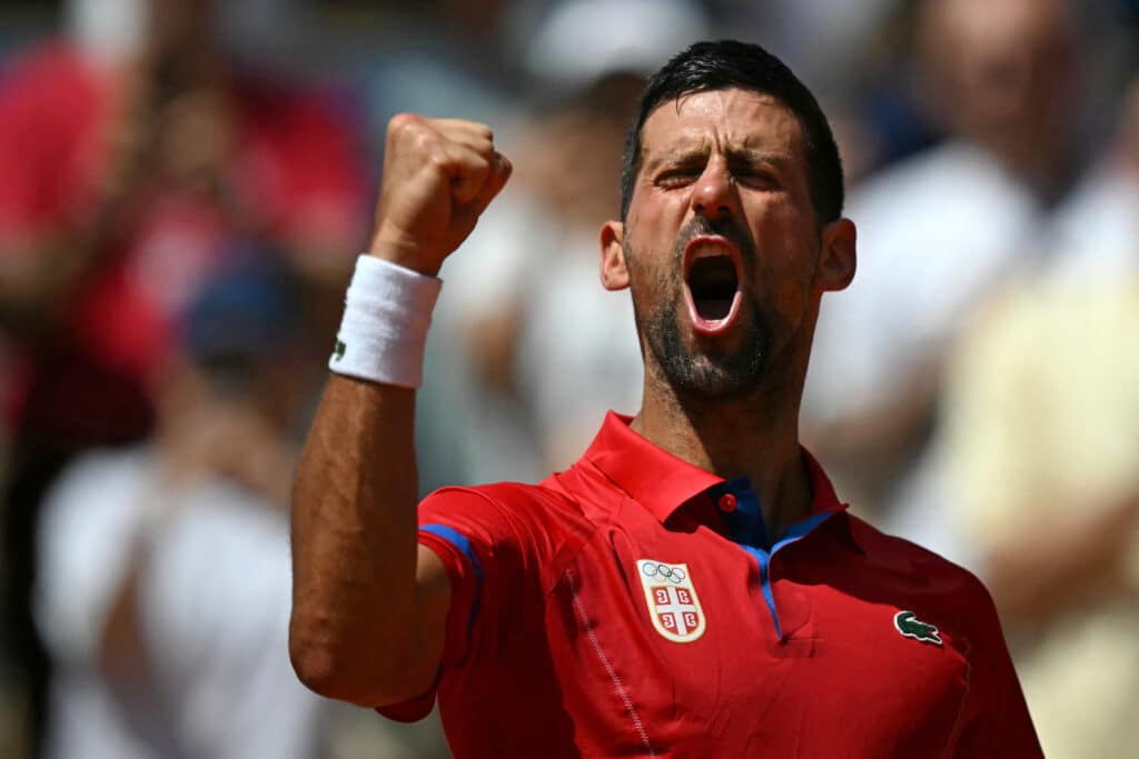 Paris Olympics tennis: Djokovic, Alcaraz heading for a showdown. Serbia's Novak Djokovic reacts to beating Germany's Dominik Koepfer during their men's singles third round tennis match on Court Philippe-Chatrier at the Roland-Garros Stadium during the Paris 2024 Olympic Games, in Paris on July 31, 2024. (Photo by CARL DE SOUZA / AFP)