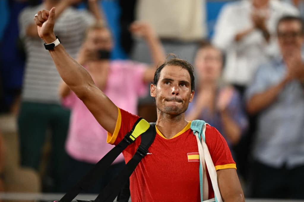 Spain's Rafael Nadal waves goodbye after he and Spain's Carlos Alcaraz lose to US' Austin Krajicek and US' Rajeev Ram in their men's doubles quarter-final tennis match. | AFP