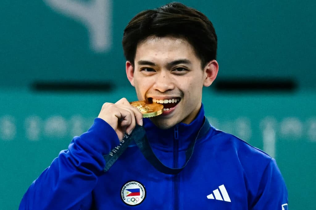 Philippines' Carlos Edriel Yulo (gold) poses during the podium ceremony for the artistic gymnastics men's vault event of the Paris 2024 Olympic Games at the Bercy Arena in Paris, on August 4, 2024. | Photo by Loic VENANCE / AFP