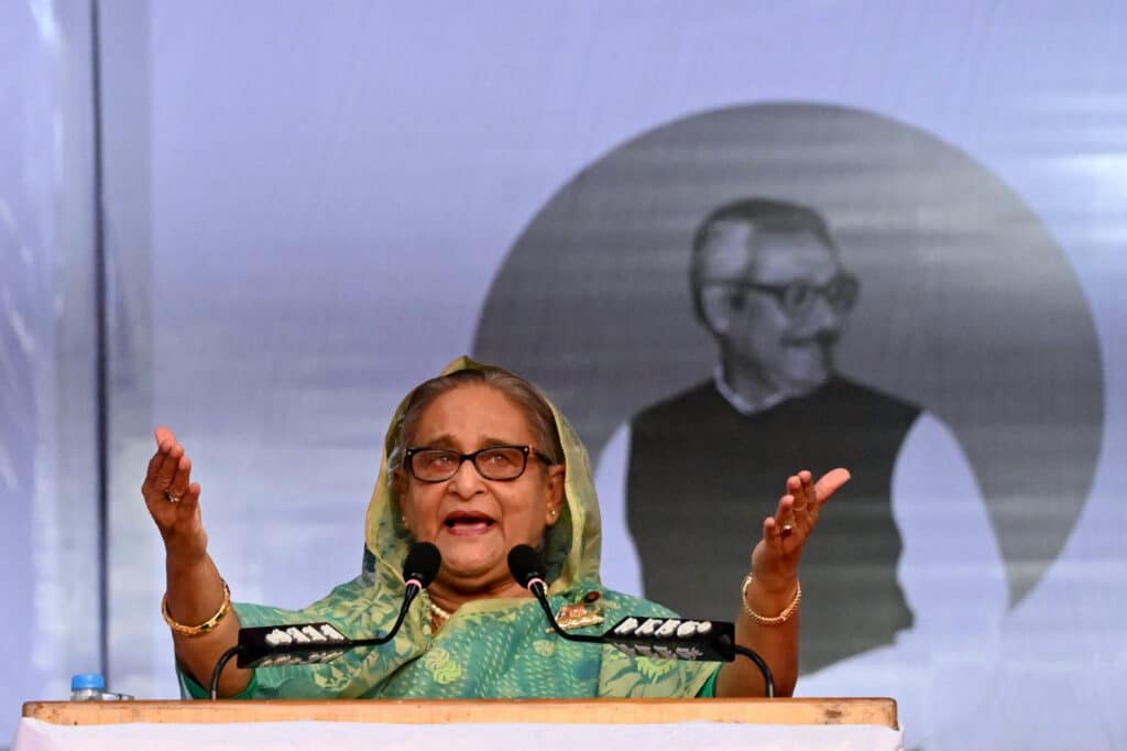 (FILES) Bangladesh's Prime Minister Sheikh Hasina addresses a rally during an election campaign in Sylhet on December 20, 2023, ahead of the general elections. Thousands of Bangladeshi protesters stormed the palace of Prime Minister Sheikh Hasina in Dhaka on August 5, 2024, with a source telling AFP she had fled mass demonstrations demanding she quit. (Photo by AFP)