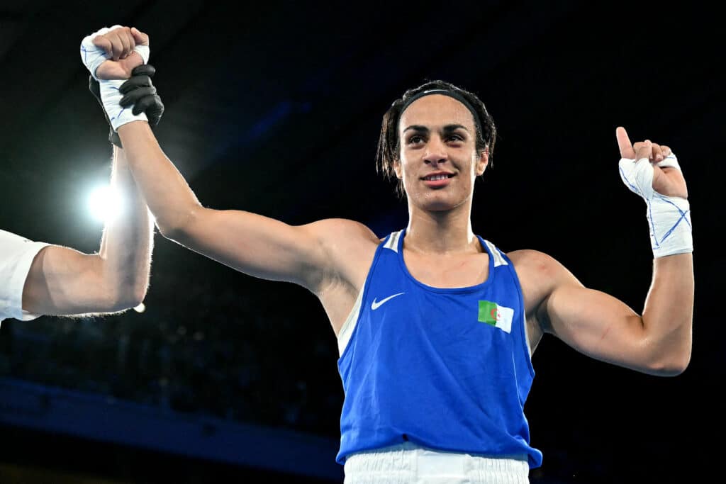 Algeria's Imane Khelif (Blue) reacts after beating Thailand's Janjaem Suwannapheng in the women's 66kg semi-final boxing match during the Paris 2024 Olympic Games at the Roland-Garros Stadium, in Paris on August 6, 2024. (Photo by MOHD RASFAN / AFP)