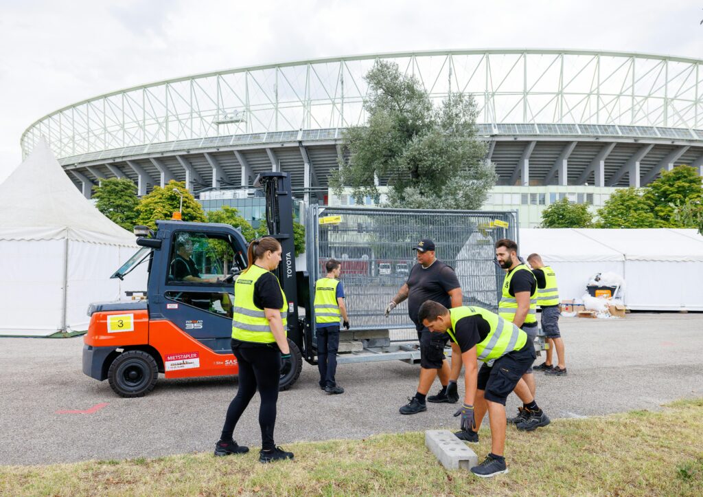 Taylor Swift shows: Foiled plot suspect hopes to kill many people. Workers remove barriers on August 8, 2024 in front of the Ernst Happel Stadium in Vienna, Austria, after the three scheduled concerts of US mega-star Taylor Swift were cancelled following the arrest of an Islamic State sympathiser in connection with an attack plot. The Vienna leg of a tour by American mega-star Taylor Swift has been cancelled after Austria arrested an Islamic State sympathiser in connection with an attack plot, the organisers said on August 7, 2024. Authorities had earlier confirmed the arrest of a 19-year-old sympathiser of the armed group for allegedly planning an attack in the Vienna region, warning he had a "focus" on Swift's three upcoming shows. About 65,000 spectators were expected at each show scheduled for August 8, 9 and 10. (Photo by FLORIAN WIESER / APA / AFP) / Austria OUT